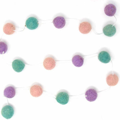 Close-up of colorful wool felt pom poms, part of an eco-friendly and fair trade home decor collection.