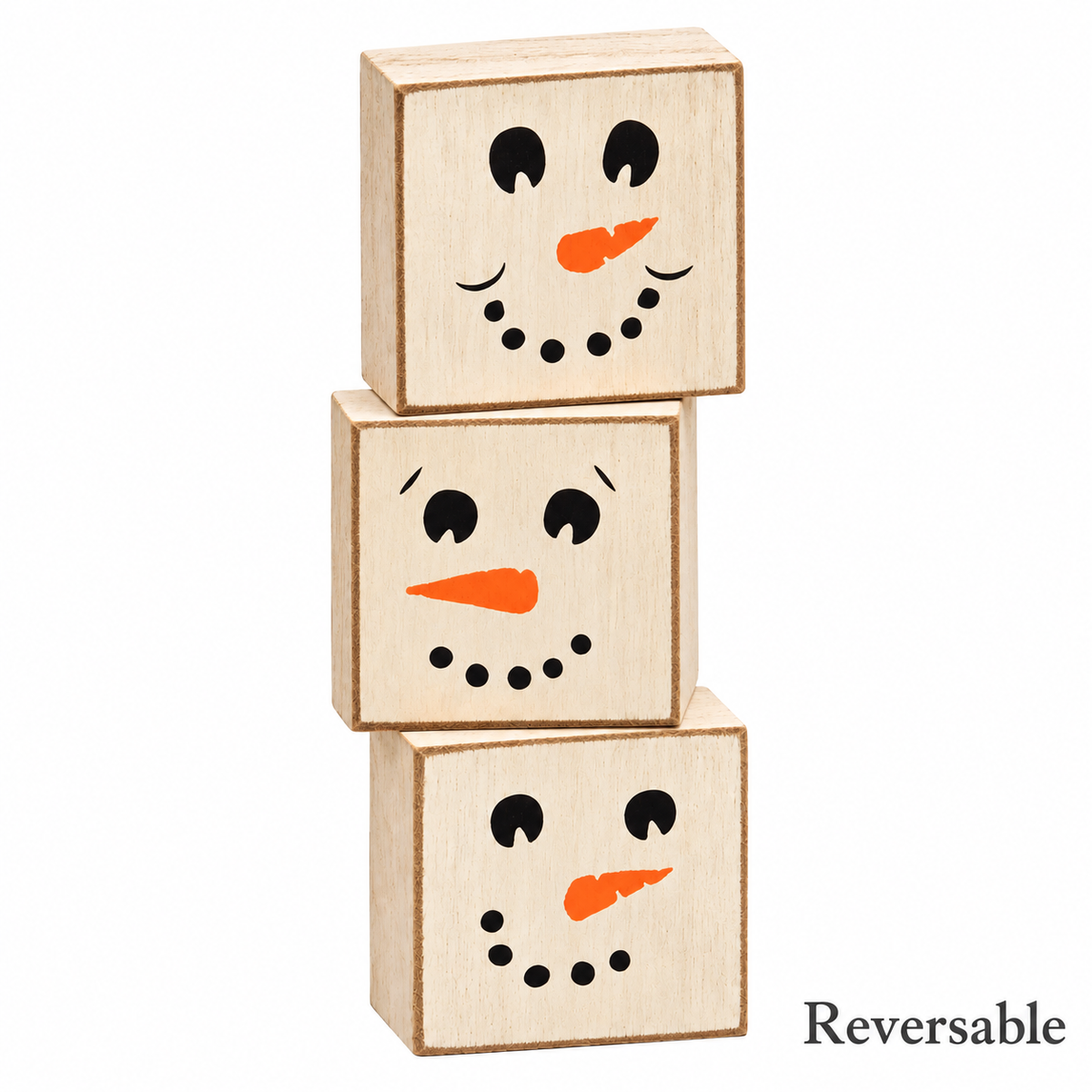 Three stacked wooden toy blocks with snowman faces, shown on a white background with the word 'Reversible' in the bottom right corner.
