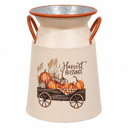 A decorative galvanized metal milk canister with a beige fabric wrap, featuring a 'Harvest Blessings' autumn illustration with pumpkins, wheat, and a wagon on a white background.