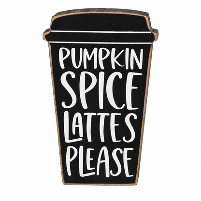 A decorative wooden sign shaped like a takeaway coffee cup with the text 'PUMPKIN SPICE Lattes Please' in white lettering on a black background, isolated on a white background.