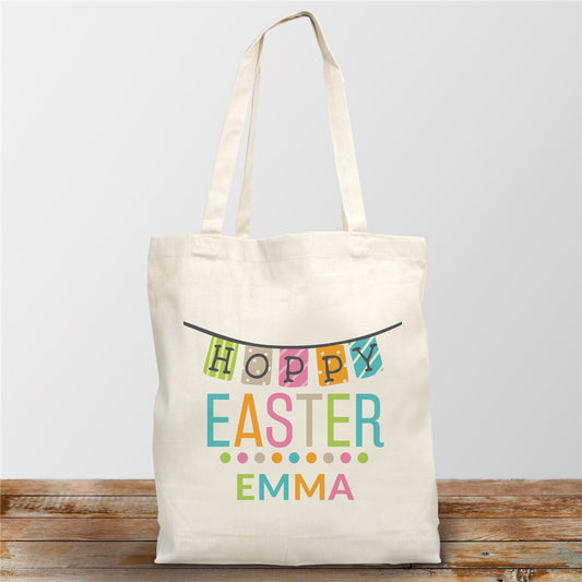 Personalized cotton tote bag featuring "Hoppy Easter" message, colorful banner design, and playful polka dots, ideal for spring celebrations and Easter egg hunts.