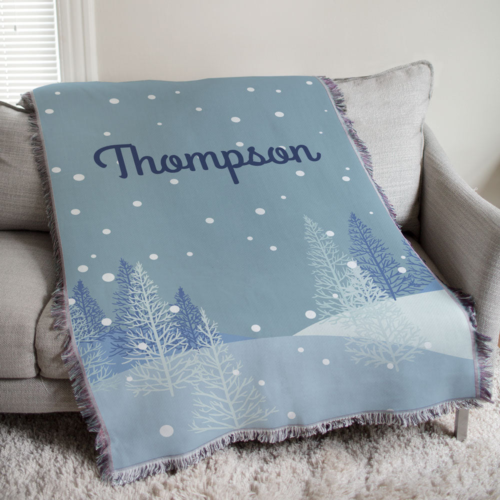 A beautifully woven Winter Forest Tapestry Throw featuring a serene forest design. Soft poly/cotton blend with fringed trim, perfect for rustic winter decor.