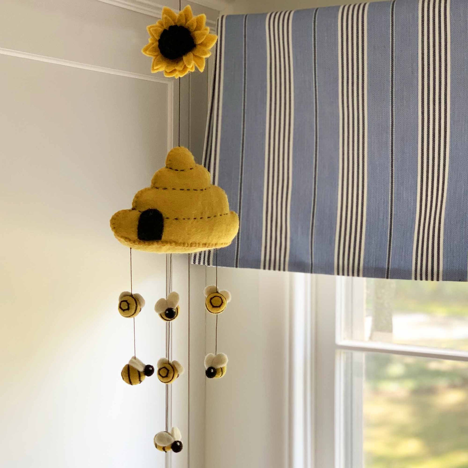 Felted wool beehive decor, perfect for a bee-themed nursery or sustainable home gift.