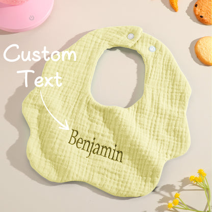 Yellow personalized baby bib with custom text overlay, showcasing the option for personalized embroidery. Ideal for birthdays or special baby gifts.