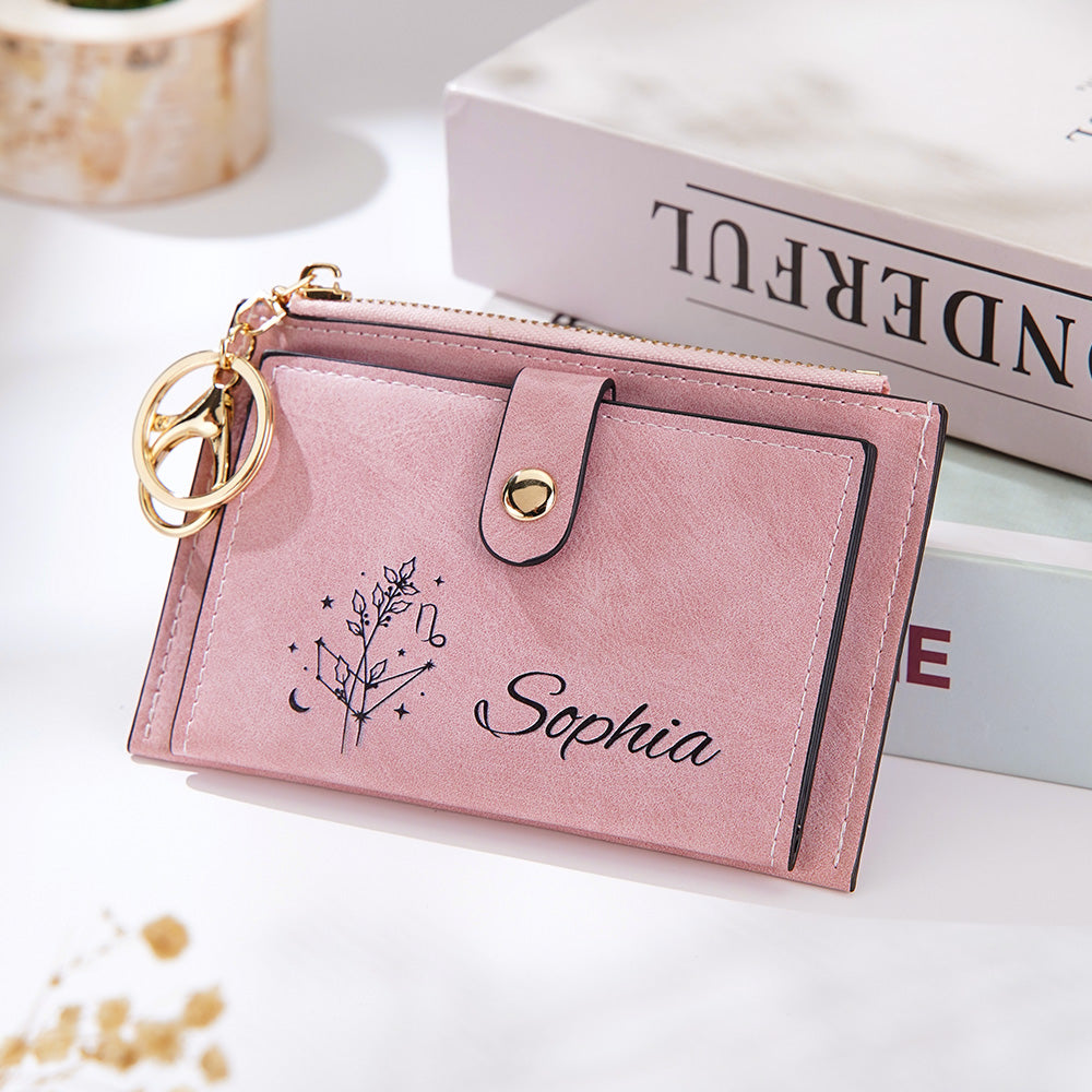 A styled shot of the pink vegan leather wallet displayed against a stack of books, showcasing its sleek and elegant design, perfect for everyday use and a thoughtful gift.