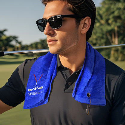 A blue golf towel with the customer's personalized embroidered last name, draped around a man's neck, showcasing its soft fabric and custom embroidery.