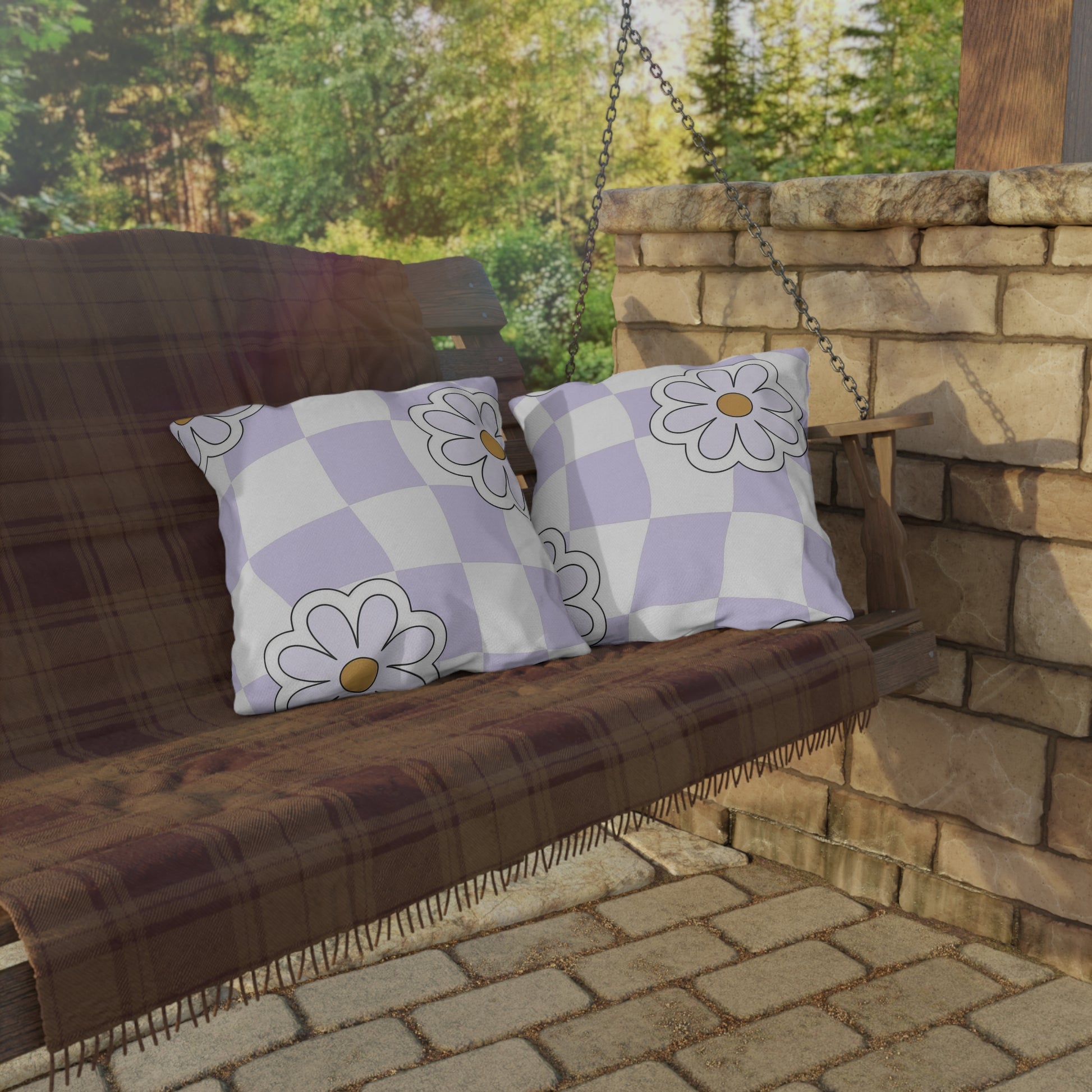 Lavender floral pillow used on metal outdoor bistro chair with greenery