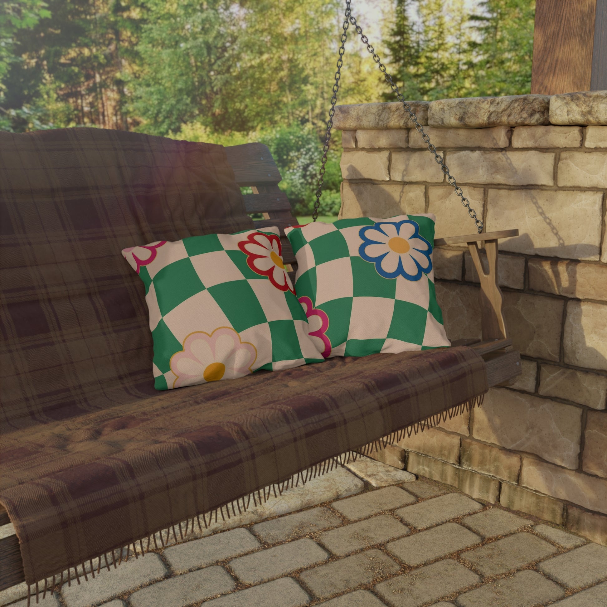 Throw pillow with green and pink pattern on a porch bench