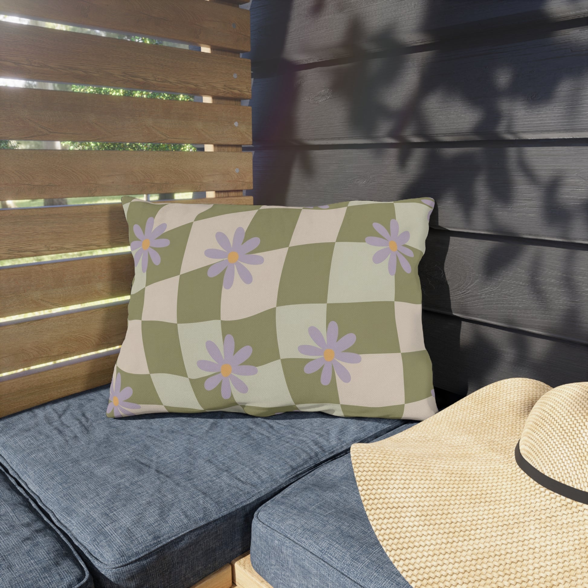 Colorful floral patio pillow featuring a retro checkered pattern, designed to add cheerful charm to outdoor lounge furniture