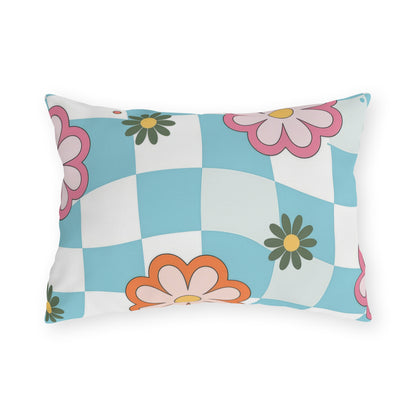 Floral outdoor lumbar pillow in blue, pink, yellow, and orange on garden bench
