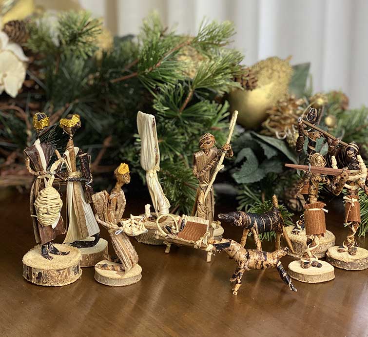 Full 11-piece Banana Fiber Nativity Set arranged in a traditional scene with the Holy Family, Wise Men, and animals.