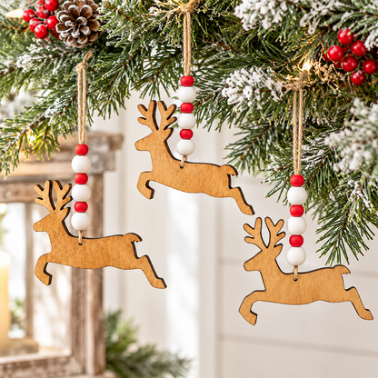 Three wooden reindeer Christmas tree ornaments with red and white bead garlands hanging from a decorated Christmas tree branch.