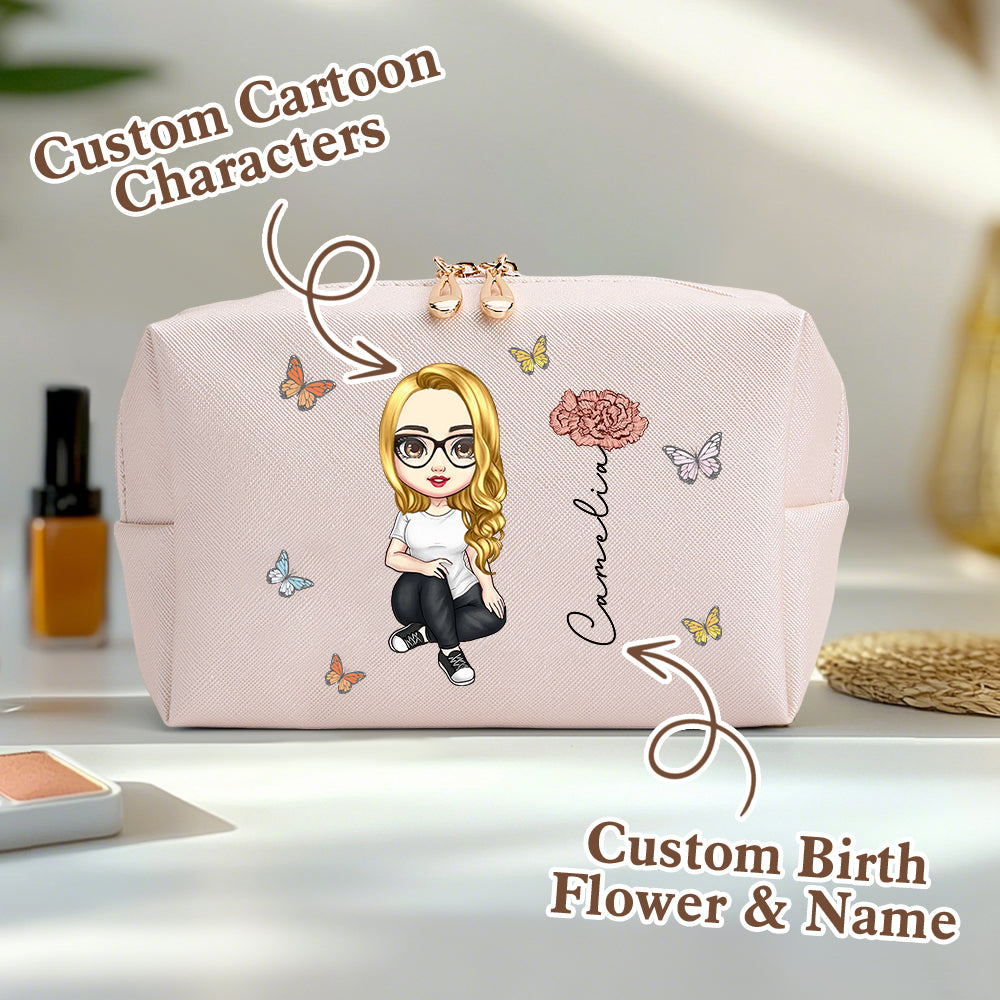 A pale pink personalized makeup bag on a table, featuring a custom cartoon character, birth flower, and name, with an overlay saying custom cartoon characters and custom birth flower and name.