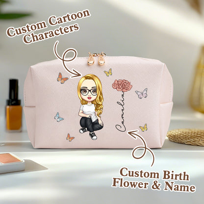 A pale pink personalized makeup bag on a table, featuring a custom cartoon character, birth flower, and name, with an overlay saying custom cartoon characters and custom birth flower and name.