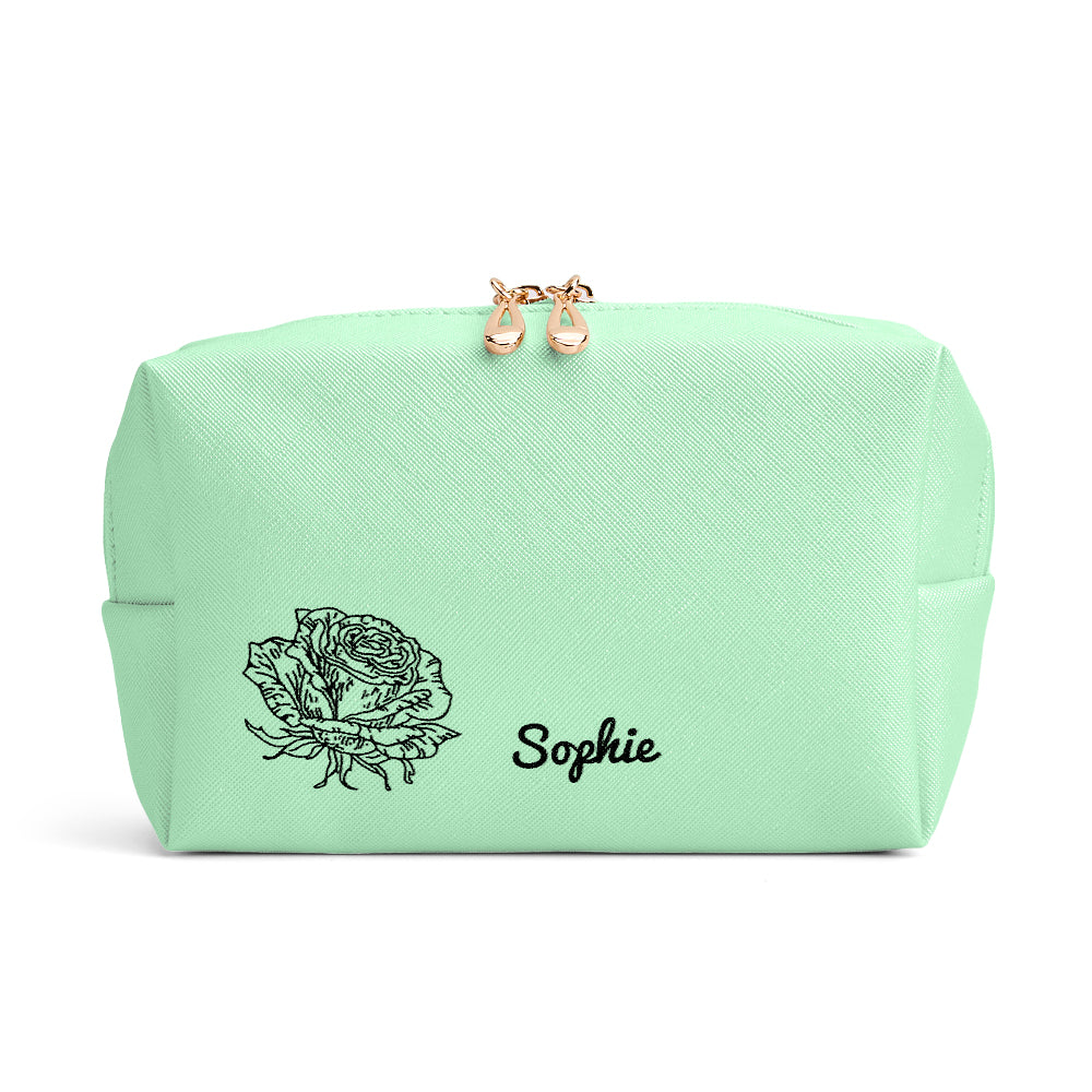 A close-up view of the green makeup bag, showcasing the birth flower and name design on the front.