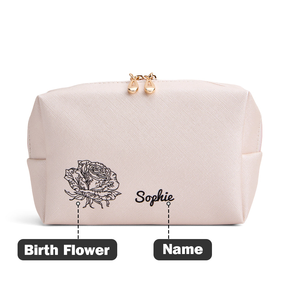 A view of the light pink makeup bag with an overlay indicating that the customer can personalize it with their chosen birth flower and name.