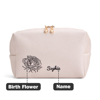 A view of the light pink makeup bag with an overlay indicating that the customer can personalize it with their chosen birth flower and name.