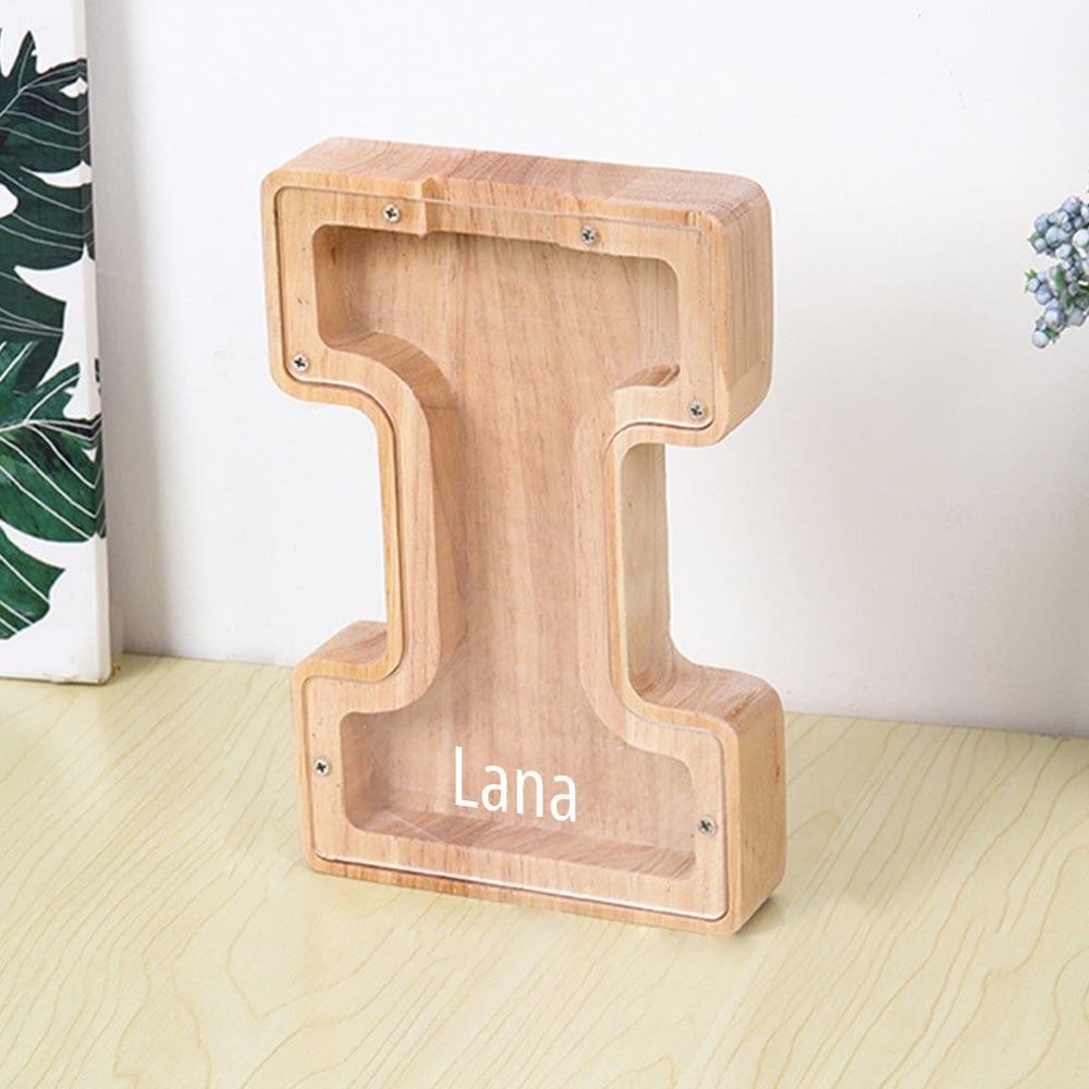 An "I" shaped piggy bank with a light wood finish and clear acrylic panel for children to monitor their savings.