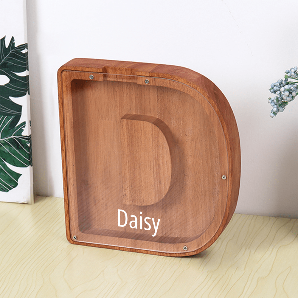 A "D" shaped piggy bank in brown, made from wood and acrylic, designed to help children save in a fun way.