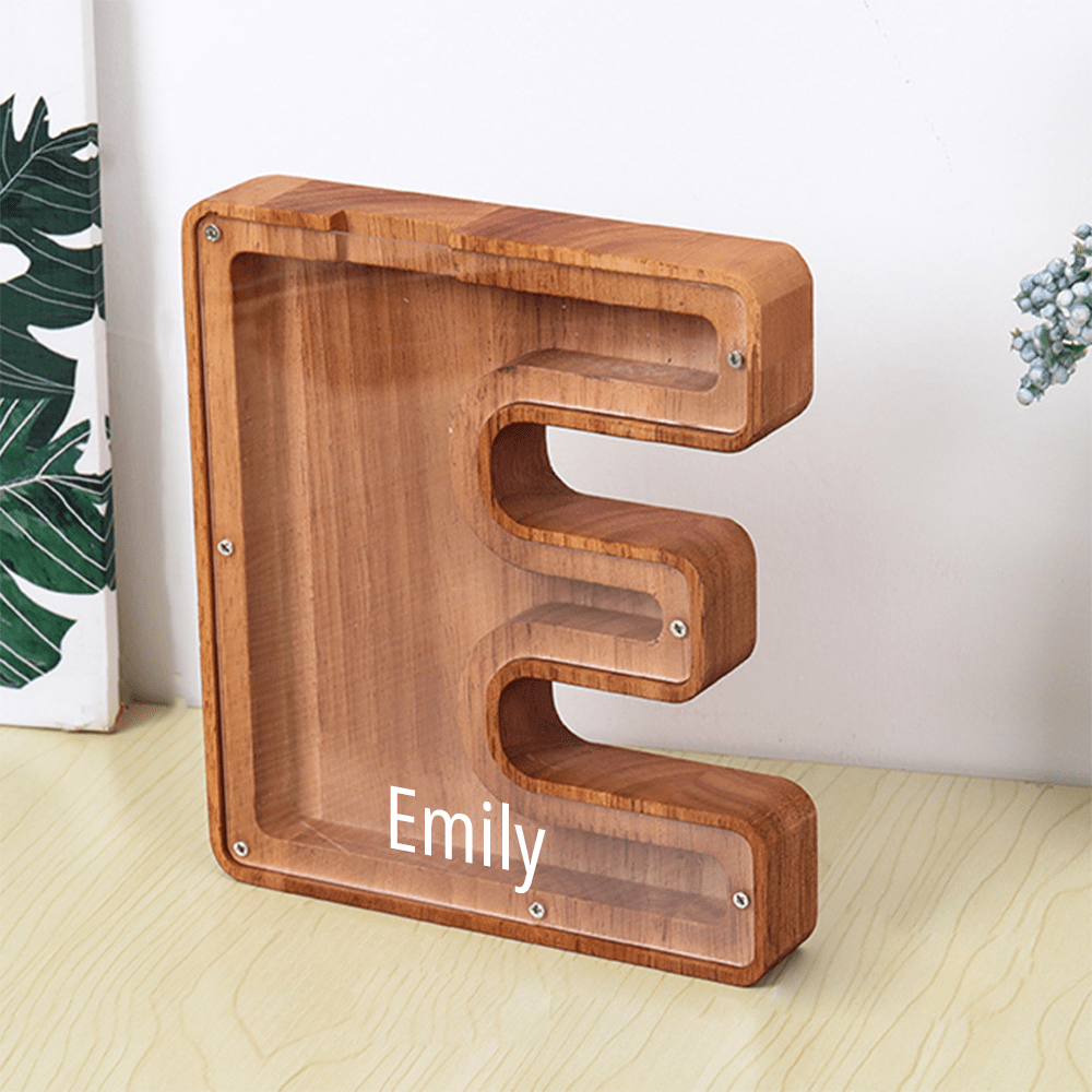 A custom "E" wooden piggy bank in brown, featuring an acrylic panel to visually track coin savings.