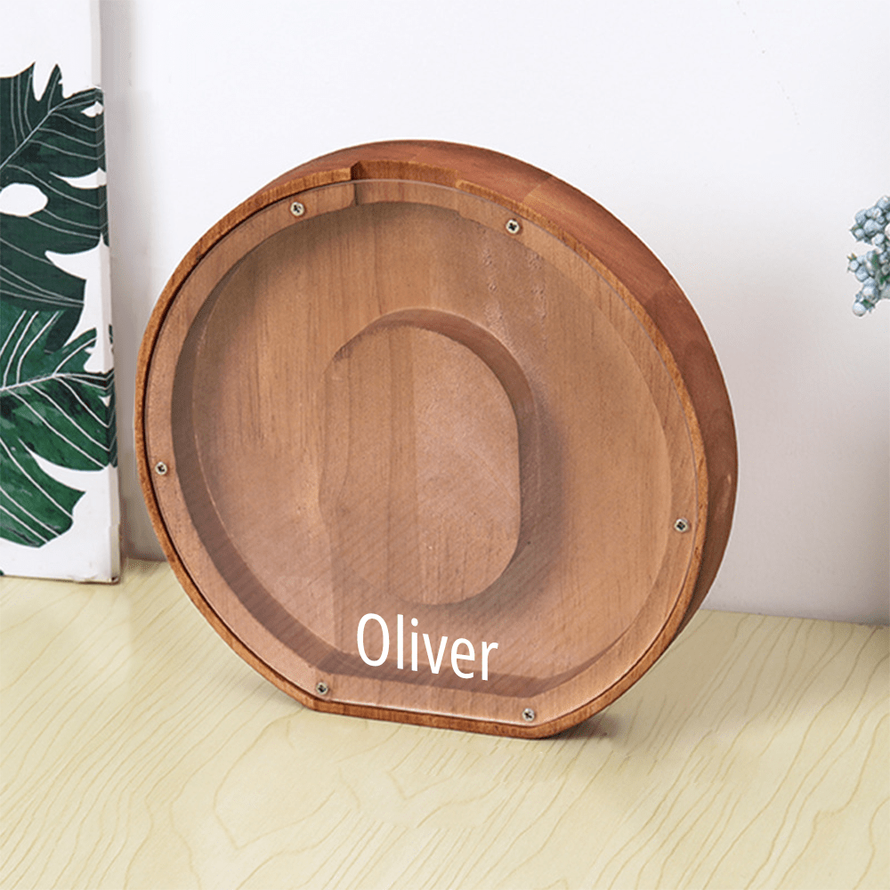 A "O" letter piggy bank in brown, made with wood and an acrylic face to monitor savings as kids add to their collection.