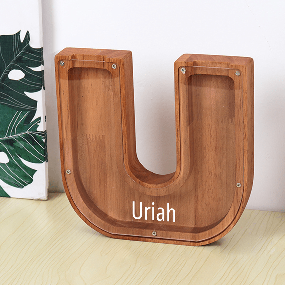 A "U" shaped piggy bank in brown with an acrylic panel, designed to help kids monitor their savings and learn the value of saving.