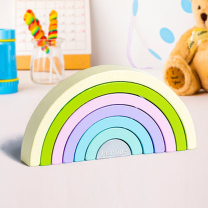 Eco-friendly wooden rainbow puzzle for kids, ideal for Montessori and Waldorf-inspired learning through stacking and balancing.