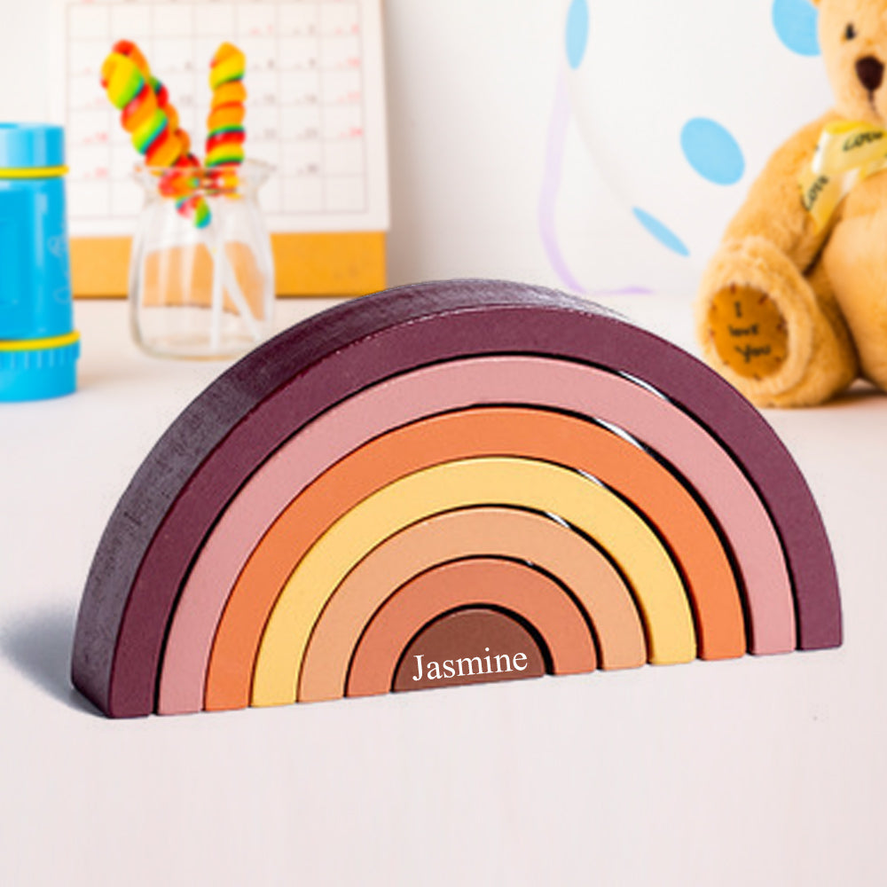 Natural wood rainbow nesting blocks, a creative toy that supports imaginative play and spatial awareness in toddlers.