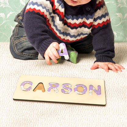 Custom engraved wooden name puzzle with colorful acrylic letters, designed for toddler fine motor skills and name recognition.