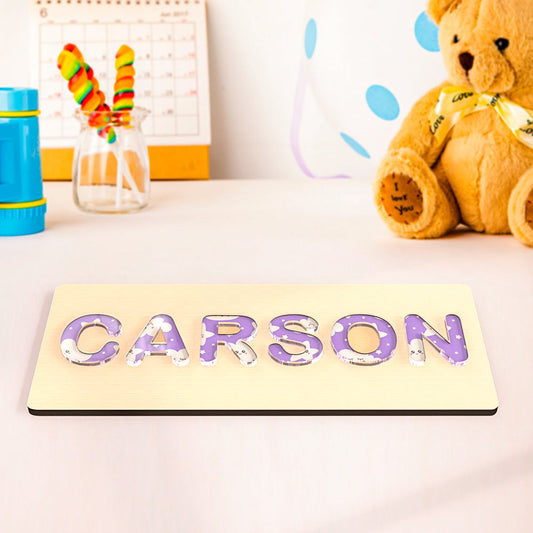 Personalized wooden name puzzle with acrylic letters in cloud, dinosaur, colorful texture, flower, or chrysanthemum designs, perfect for toddlers and early learning.