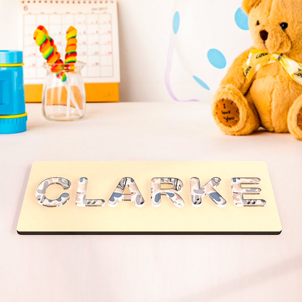 Handmade Montessori name puzzle in vibrant acrylic designs, featuring cloud, dinosaur, flower, chrysanthemum, or colorful textures for fun learning.