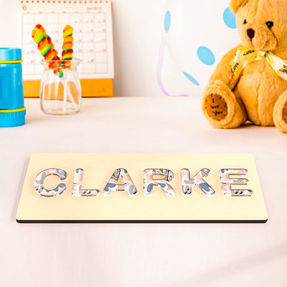 Handmade Montessori name puzzle in vibrant acrylic designs, featuring cloud, dinosaur, flower, chrysanthemum, or colorful textures for fun learning.