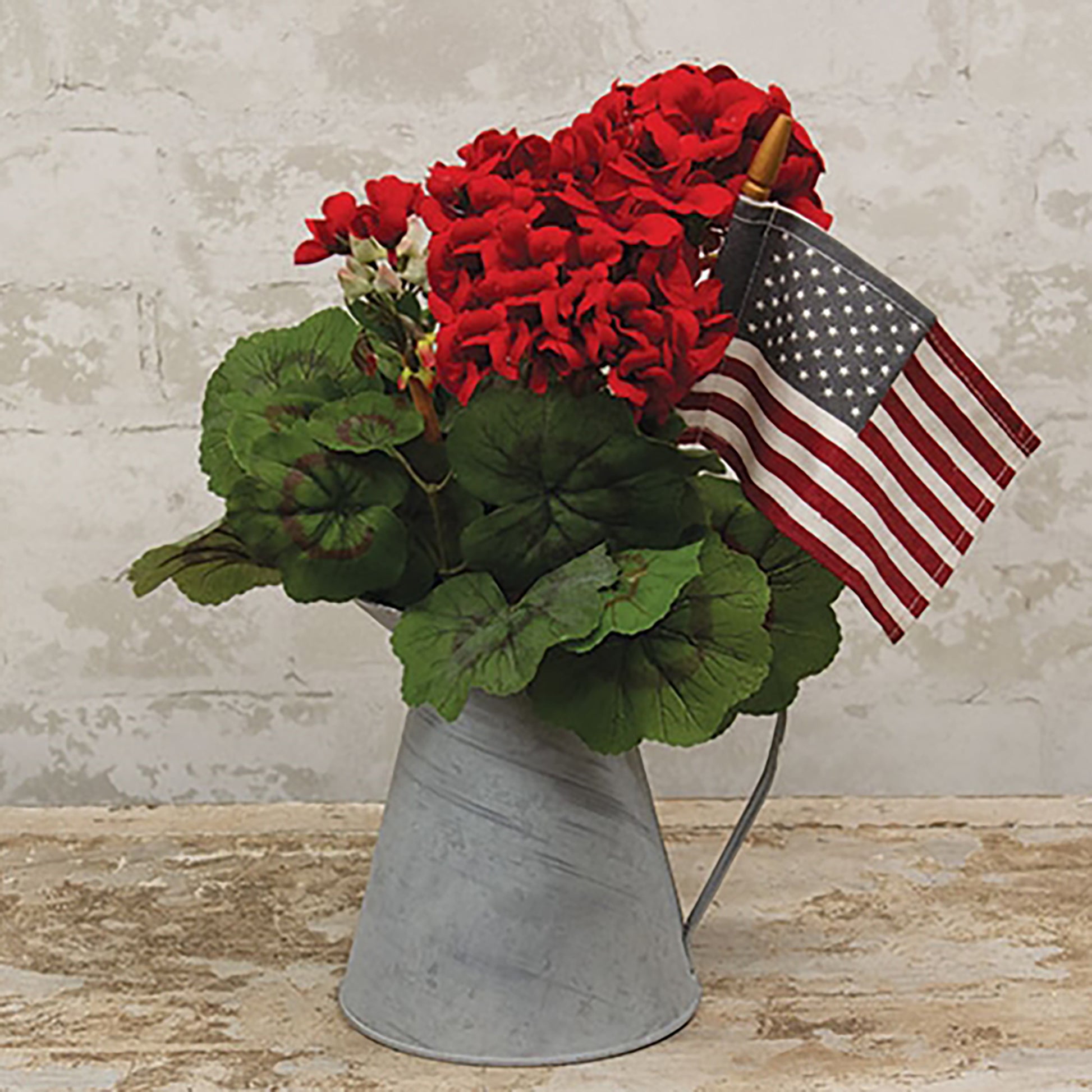 Artificial red geranium floral stem arranged in rustic country farmhouse decor