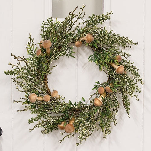Woodland-style wreath with green foam leaves and sprouting mushrooms on a brown-wrapped base