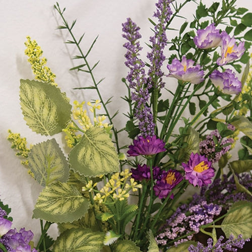 Artificial floral wreath with green-wrapped base and layered purple flowers