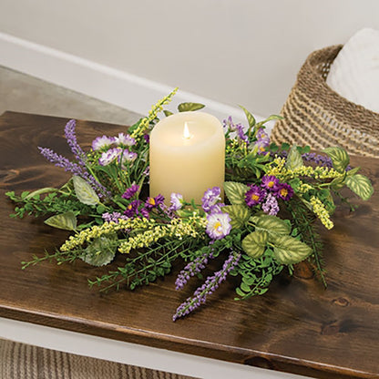 Amethyst Garden floral ring surrounding a pillar candle in a tabletop display