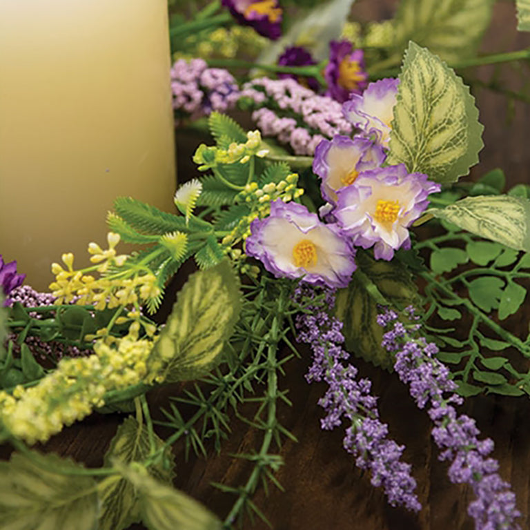 Decorative purple and green candle ring with realistic texture and layered foliage