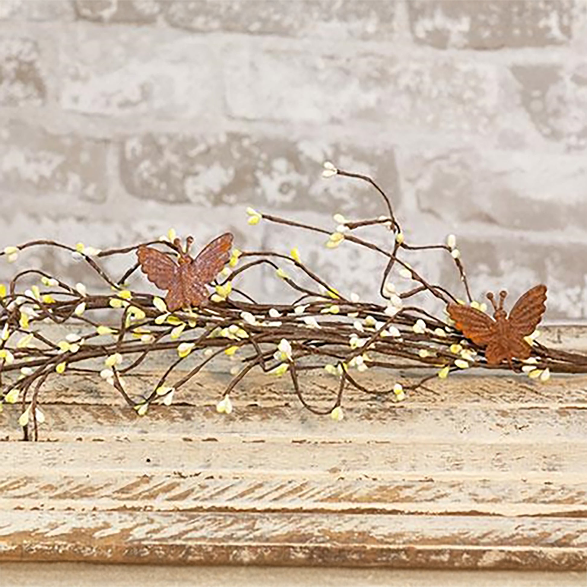 Rustic pip berry butterfly garland with citron berries and wispy farmhouse spring styling