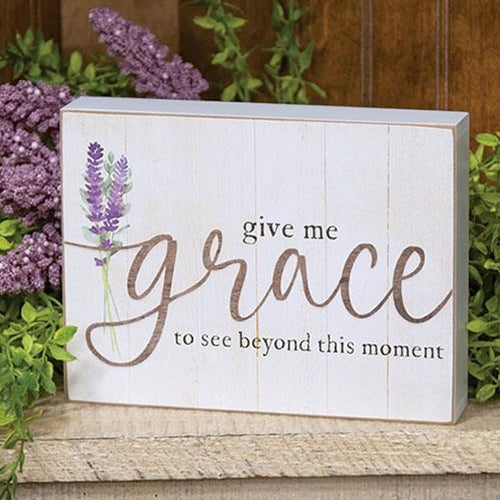 Rustic wooden box sign with lavender illustration and the quote "give me grace to see beyond this moment," displayed on a white shiplap background.
