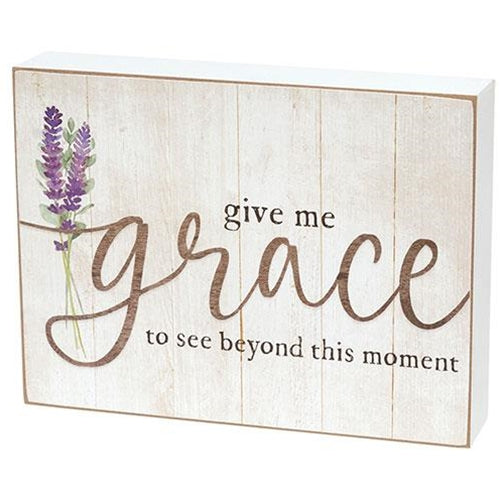 Inspirational farmhouse-style box sign featuring purple lavender art and soft black and taupe lettering on a distressed white wood background.