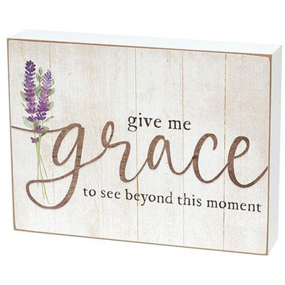 Inspirational farmhouse-style box sign featuring purple lavender art and soft black and taupe lettering on a distressed white wood background.