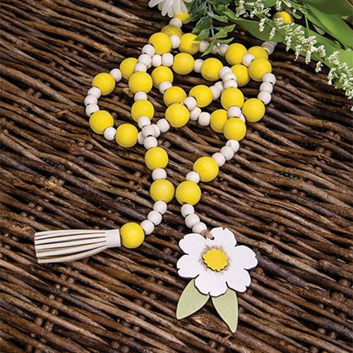 Jute rope garland featuring rustic beads and white and yellow floral tag