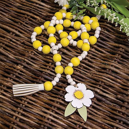 Jute rope garland featuring rustic beads and white and yellow floral tag