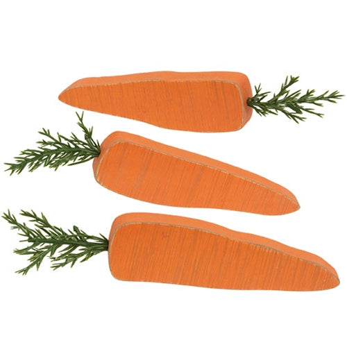 Rustic wood carrot figurines styled in a decorative tray for spring or Easter decor
