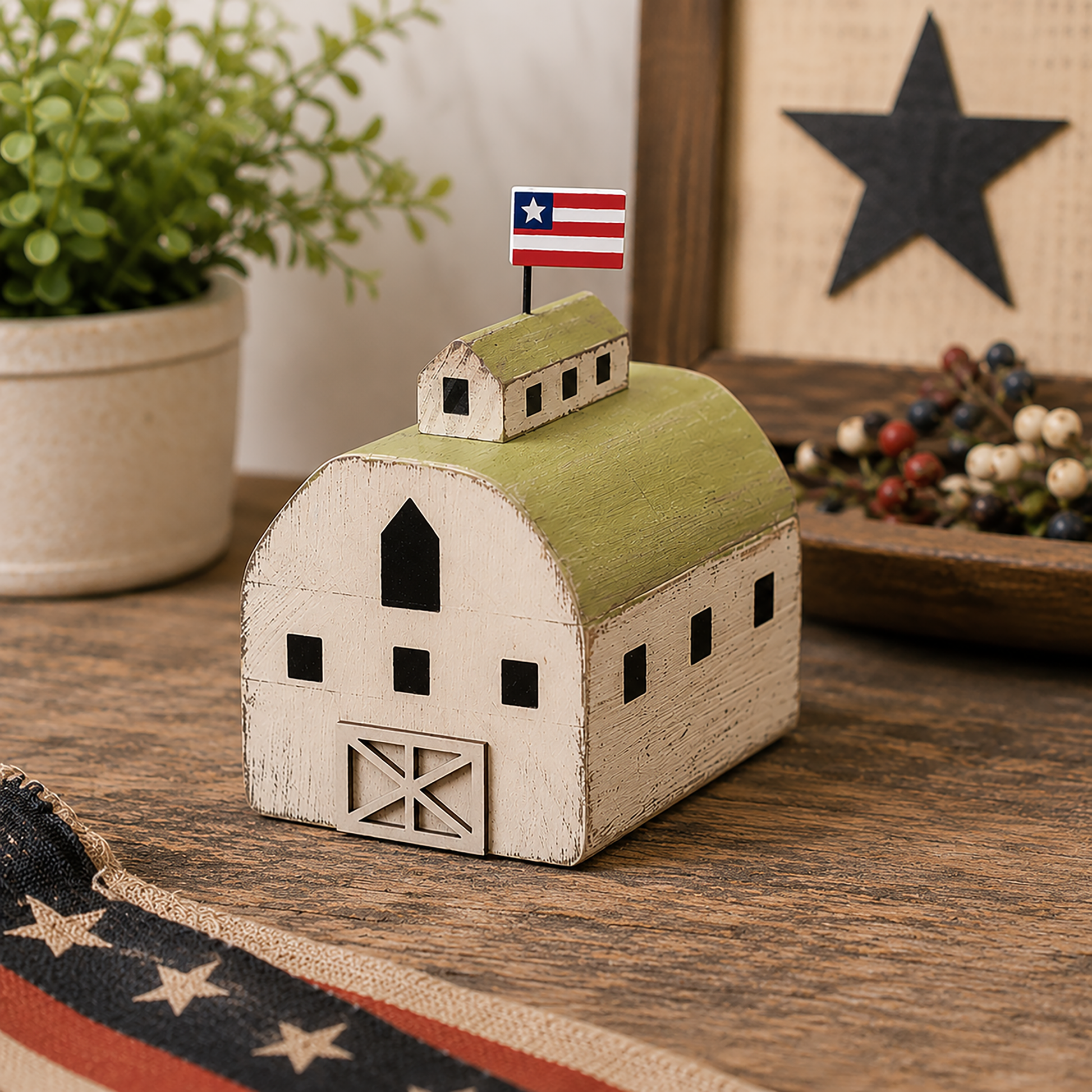 Distressed Americana wooden barn figure with layered green roof, patriotic flag detail, and rustic farmhouse styling