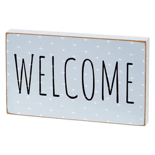 Welcome block with white plus signs and distressed finish
