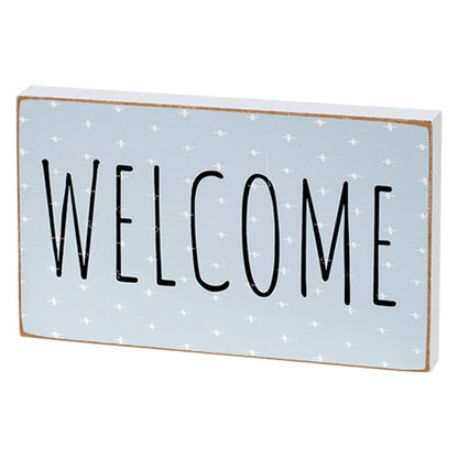 Welcome block with white plus signs and distressed finish