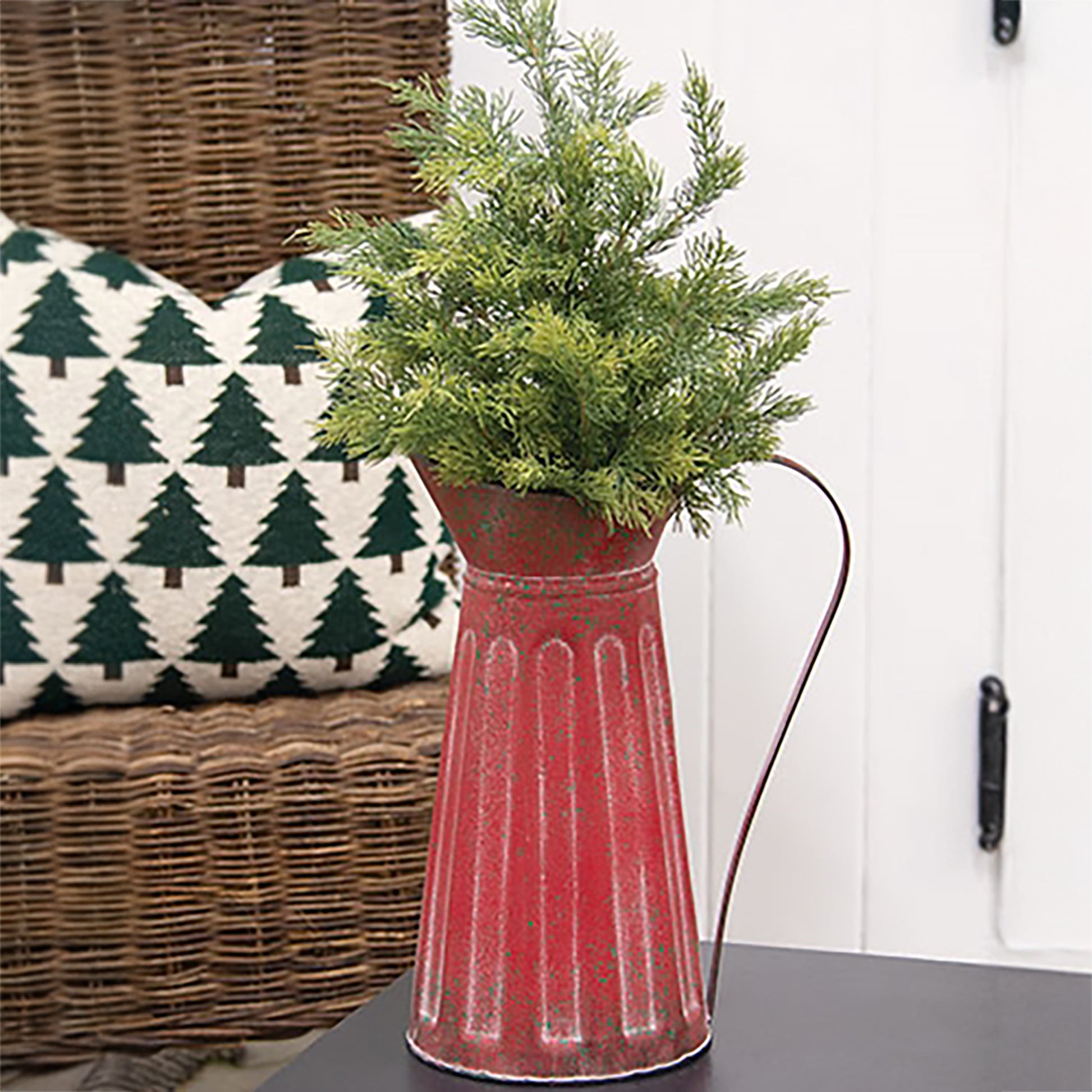 Distressed red ribbed metal pitcher with green splatter farmhouse Christmas styling and rustic holiday decor