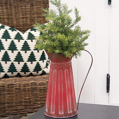 Distressed red ribbed metal pitcher with green splatter farmhouse Christmas styling and rustic holiday decor