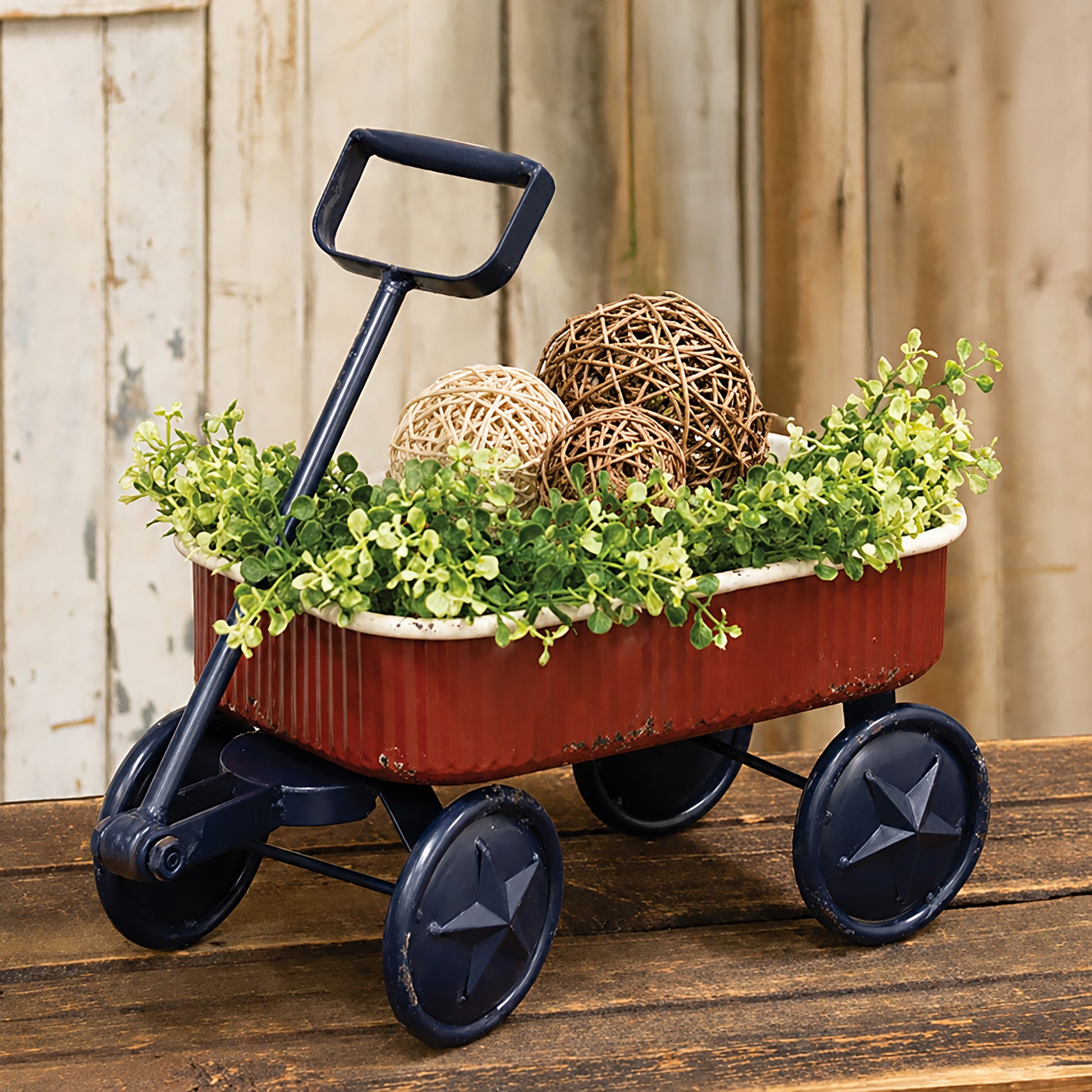 Rustic Americana metal wagon with distressed red finish navy star wheels and vintage patriotic farmhouse decor styling